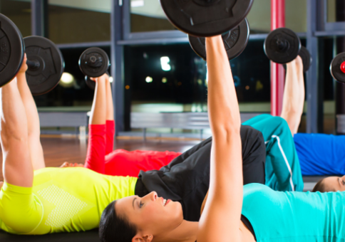 A group exercise class lift weights