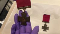 A close up of the back of a Victoria Cross medal with 'Lieutenant F. N. Parsons' engraved on it.   preview