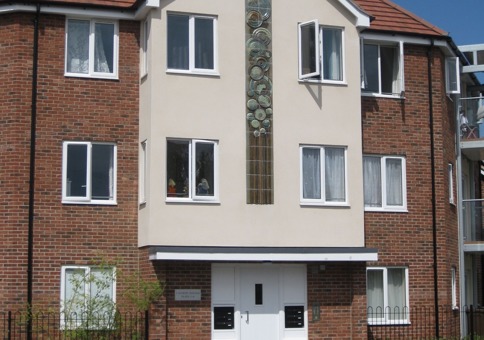 Ceramic panel embedded into the front of a three-storey block of flats