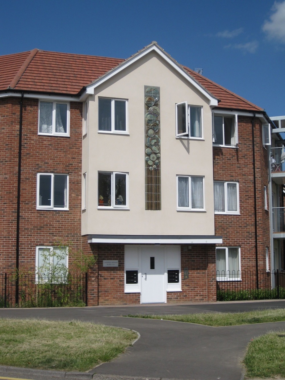 Ceramic panel embedded into the front of a three-storey block of flats