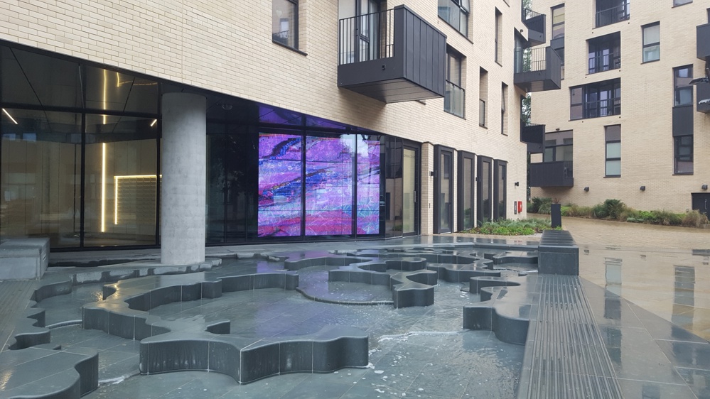 Video screens on the ground floor window to the tower overlooking the saltmarsh pool