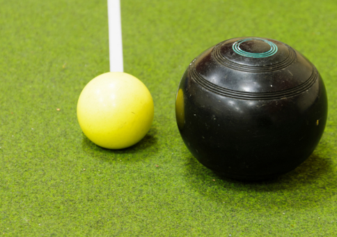 Bowls balls on an indoor green astroturf.