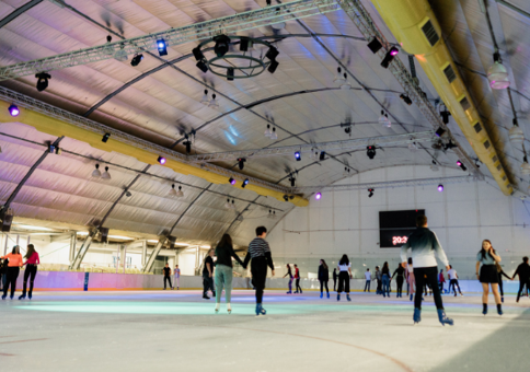 Lots of people skating on the indoor ice rink at Riverside