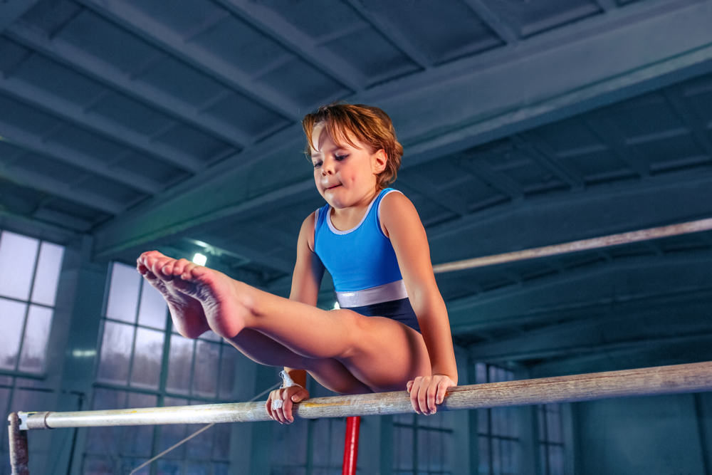 Girl balancing on gymnastics equipment