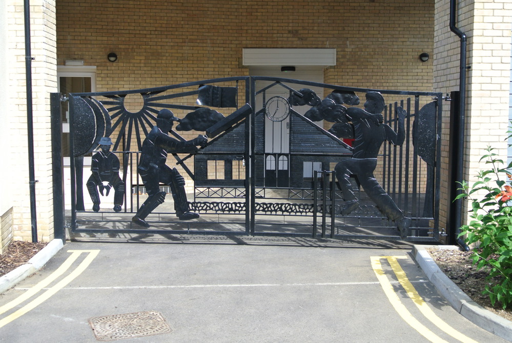 Wrought iron gates featuring cricketing figures