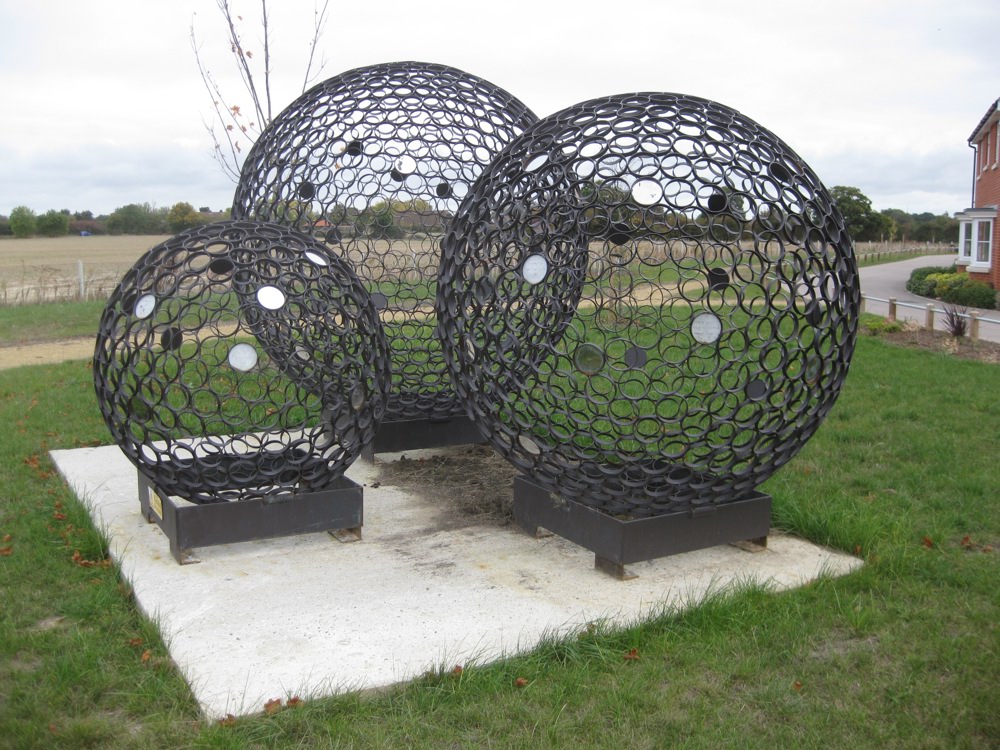 Three large metal spheres made of smaller circles