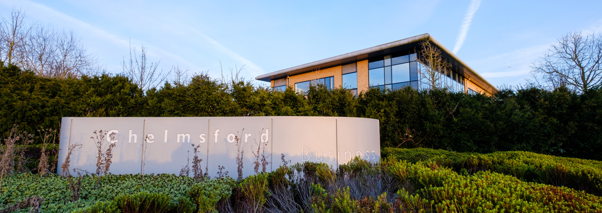 'Chelmsford business' sign in front of large office building