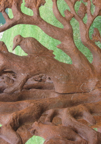 Spherical sculpture made from a metal depicting oak tree