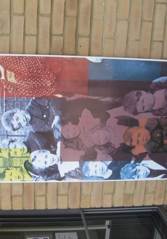 Vitreous enamel panel featuring photograph of nine children and a woman from Victorian or Edwardian era