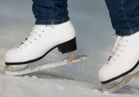 Woman wearing white ice skating boots