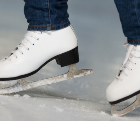 Woman wearing white ice skating boots