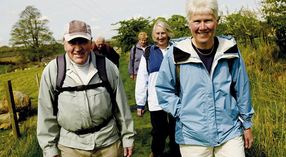 Group of older people walking in countryside