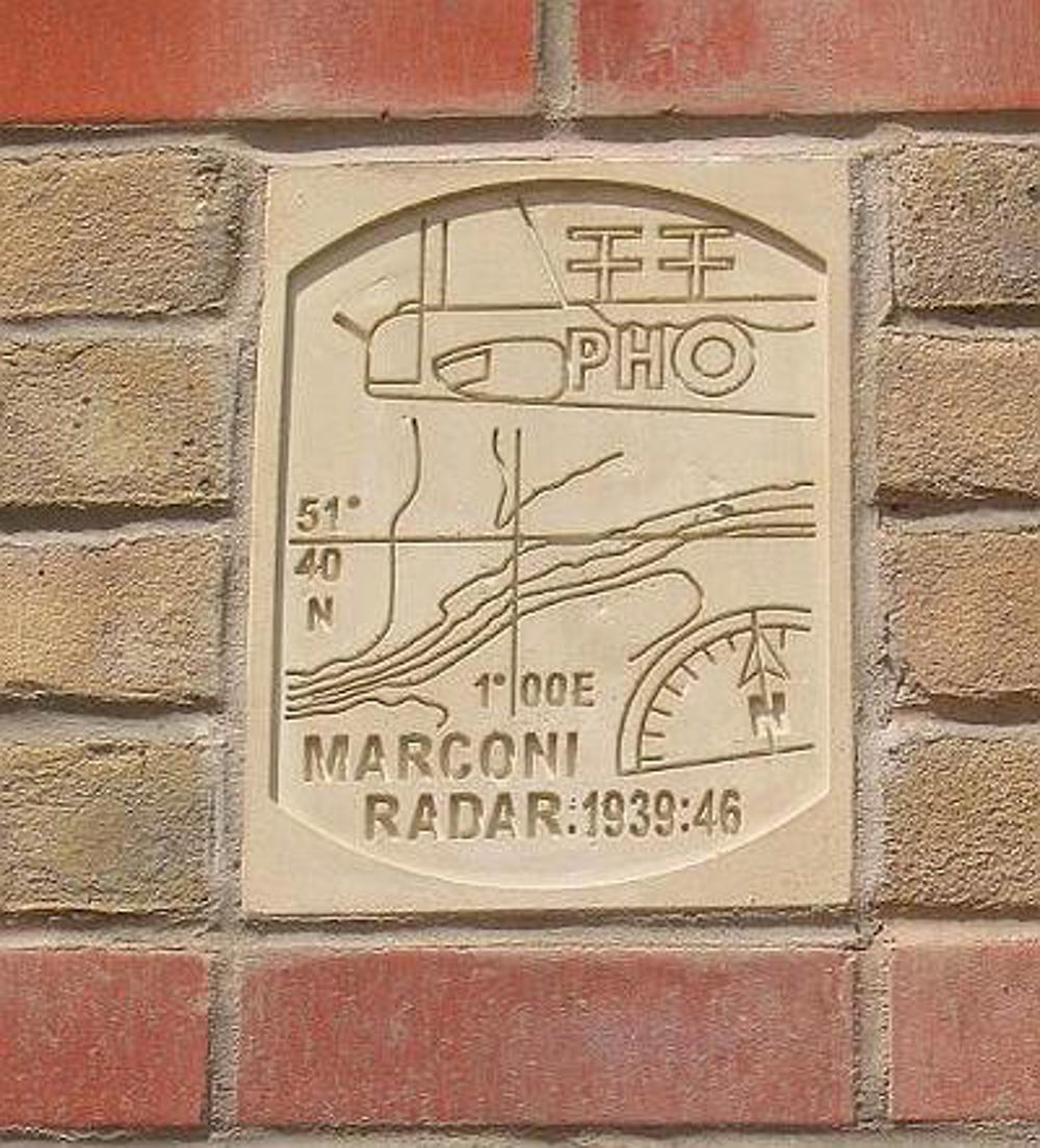 Stone plaque on a brick wall saying 'Marconi Radar: 1939:46'