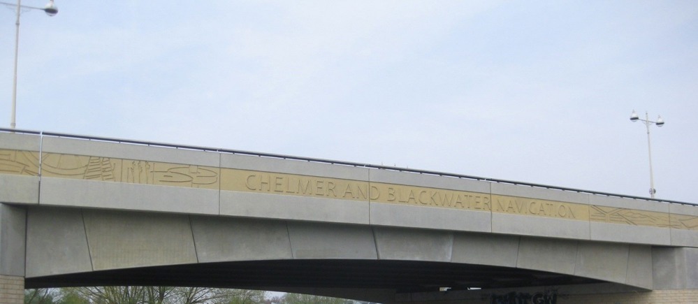 Pictures engraved on bridge with the words 'Chelmer and Blackwater Navigation'