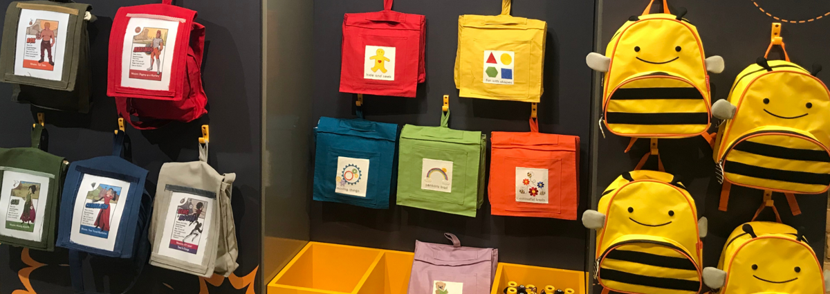 Colourful children's backpacks on wall display