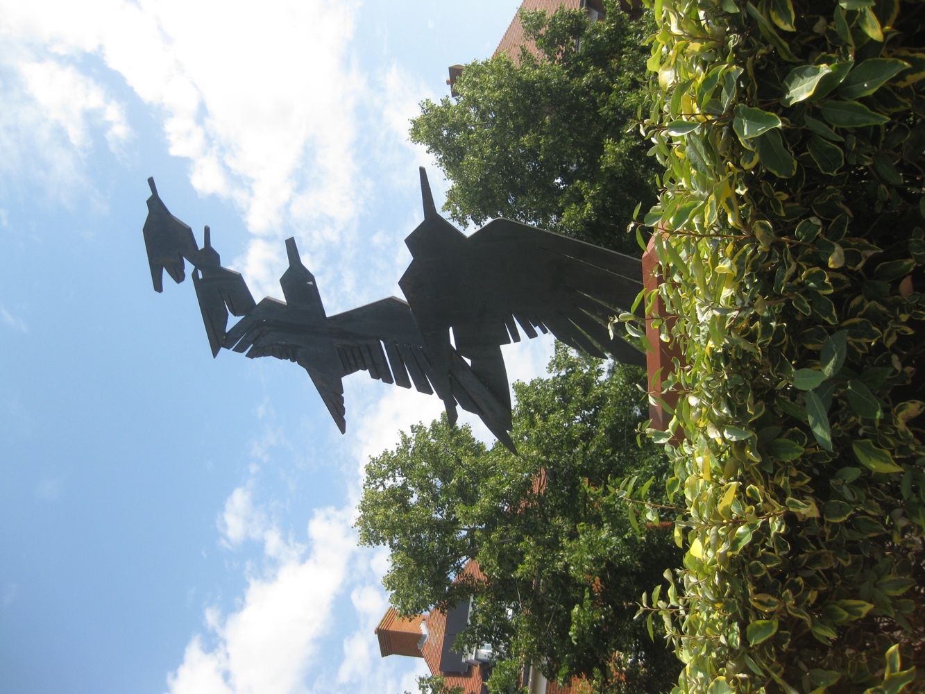 Sculpture depicting four black steel birds in flight, of decreasing sizes