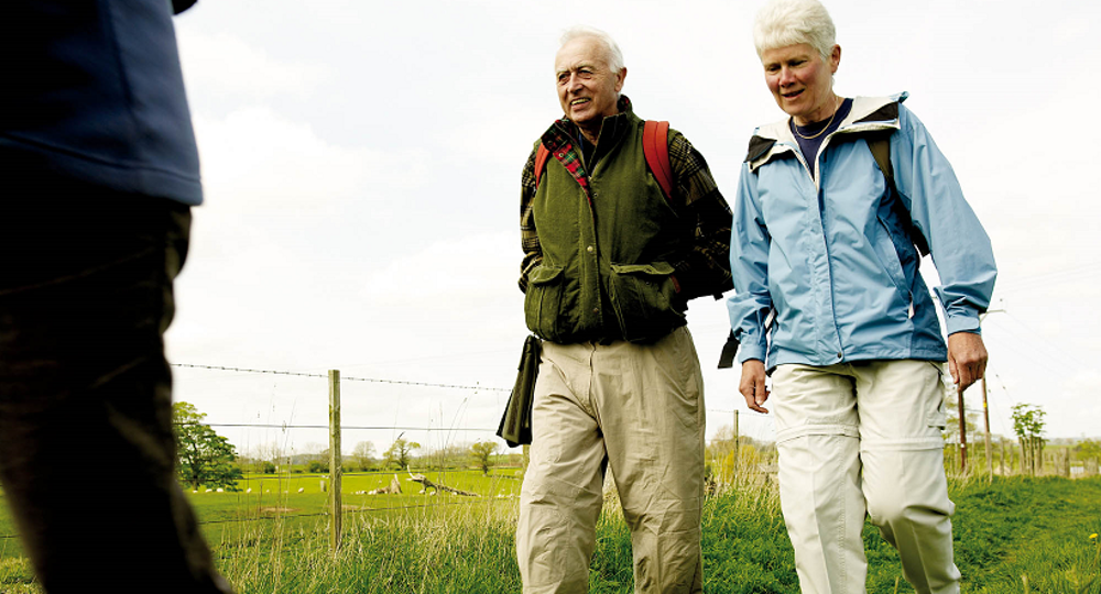 Older couple on a walk through some fields