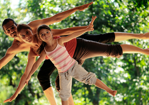 Man, woman and child all balancing on one leg