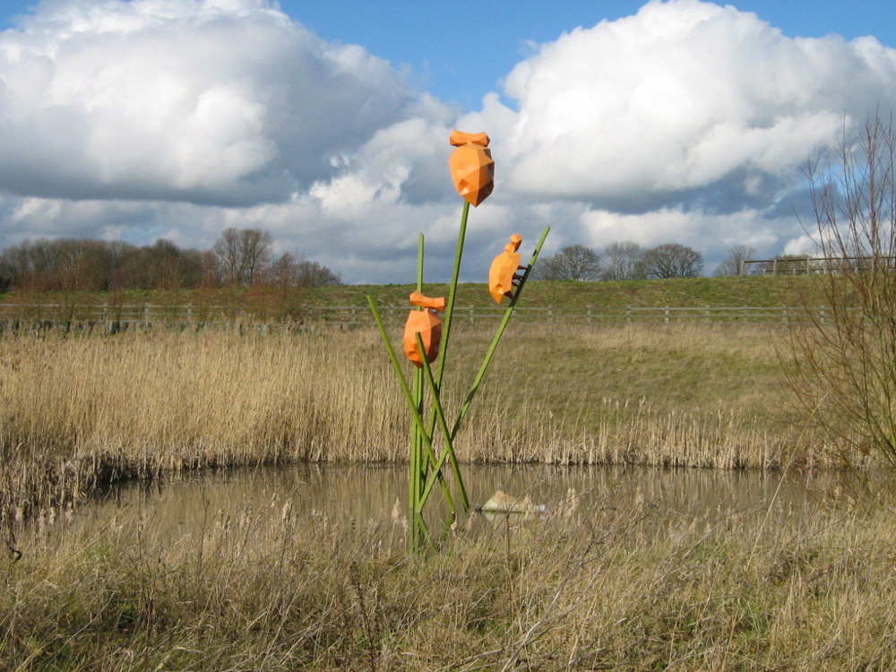 Sculpture of large orange bugs climbing on green stems