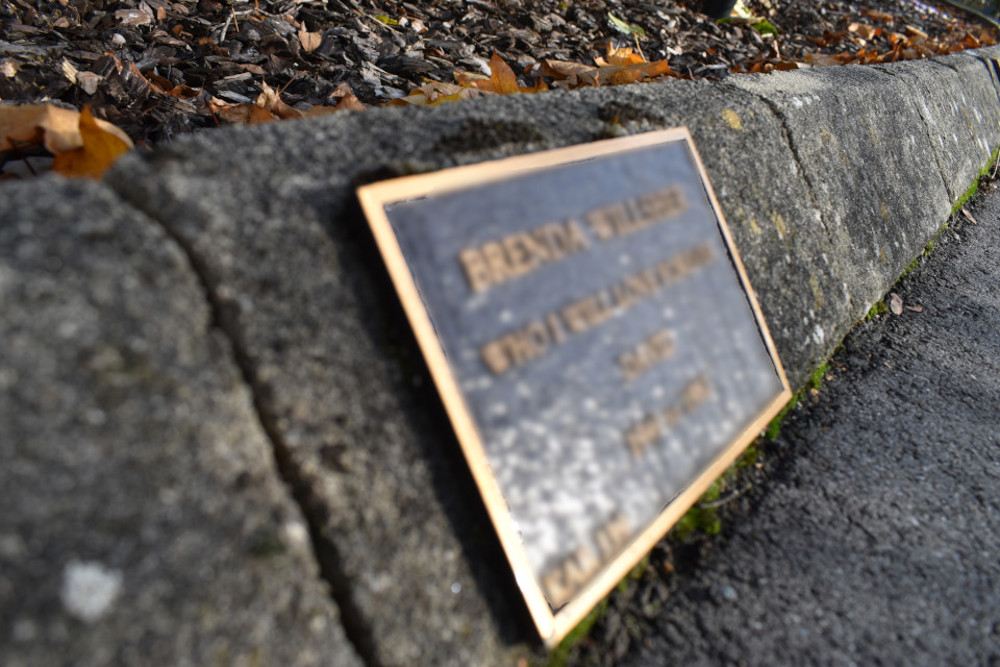 Small plaque fixed to kerbstone