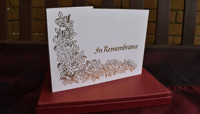 White card with gold decoration and 'In Remembrance' lettering preview